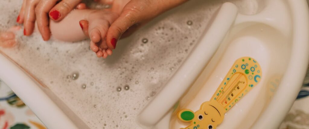Woman washes babies feet